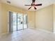 A bright living room with a sliding door that opens to a screened in pool at 100 Grand Reserve Dr, Davenport, FL 33837