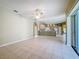 An open-concept living room showcases tile flooring and flows into a kitchen area with bar seating at 100 Grand Reserve Dr, Davenport, FL 33837