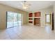 Bright living room featuring tile flooring, built-in shelving, and access to a screened-in pool area at 100 Grand Reserve Dr, Davenport, FL 33837