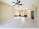 A large living room featuring tiled flooring, ceiling fan and arch window at 100 Grand Reserve Dr, Davenport, FL 33837