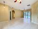 A bright living room featuring tiled flooring, ceiling fan and sliding glass doors to the pool area at 100 Grand Reserve Dr, Davenport, FL 33837