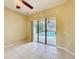 Bright living room featuring tile floors and sliding doors looking out to the pool at 100 Grand Reserve Dr, Davenport, FL 33837