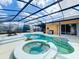 Screened-in pool and spa with a spacious deck offers a luxurious outdoor living and entertaining space at 100 Grand Reserve Dr, Davenport, FL 33837