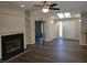 Bright living room with a fireplace, fan, and lots of natural light at 100 Se 81St St, Ocala, FL 34480