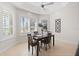 Dining room with a modern table, decor, plantation shutters, and an airy ambiance at 1044 Alcove Loop, The Villages, FL 32162