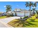 Charming home featuring a well-manicured lawn and a three car garage at 1044 Alcove Loop, The Villages, FL 32162