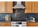 Kitchen featuring stone backsplash, cabinets, and a stainless steel range at 1044 Alcove Loop, The Villages, FL 32162