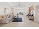 Bright living room features tile floors, tray ceilings, ceiling fan, and a decorative accent wall at 1044 Alcove Loop, The Villages, FL 32162