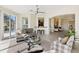 Living room with a ceiling fan and sliding glass doors to the outdoor view at 1044 Alcove Loop, The Villages, FL 32162