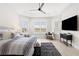 This main bedroom is bright and airy, with plantation shutters and a tray ceiling at 1044 Alcove Loop, The Villages, FL 32162