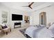 This bright and airy main bedroom features neutral walls, a modern ceiling fan, and plantation shutters at 1044 Alcove Loop, The Villages, FL 32162