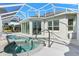 Outdoor living with covered pool, hot tub, and home exterior at 1044 Alcove Loop, The Villages, FL 32162