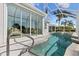 Covered pool area with hot tub and view from patio doors at 1044 Alcove Loop, The Villages, FL 32162