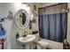 Bathroom featuring unique mirror, pedestal sink, and decorative elements at 10909 Mattioda Rd, Groveland, FL 34736