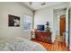 Bright bedroom featuring hardwood floors, a dark wood dresser, and neutral decor at 10909 Mattioda Rd, Groveland, FL 34736