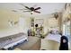 Bedroom showcasing two beds, a ceiling fan, and decorative wall art, offering a cozy atmosphere at 10909 Mattioda Rd, Groveland, FL 34736