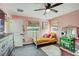 Comfortable bedroom with two windows, ceiling fan, and a vintage vanity at 10909 Mattioda Rd, Groveland, FL 34736