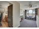 Bright bonus room with large arched window, built-in bookshelves, and cozy reading nook featuring storage baskets at 10909 Mattioda Rd, Groveland, FL 34736