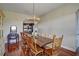 Inviting dining room with wood table, wooden chairs, and elegant antler chandelier at 10909 Mattioda Rd, Groveland, FL 34736