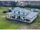 Stunning two-story home featuring a metal roof and a charming wraparound porch at 10909 Mattioda Rd, Groveland, FL 34736