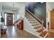 Welcoming foyer with staircase, and a decorative chandelier creating a grand entrance at 10909 Mattioda Rd, Groveland, FL 34736