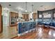 Modern kitchen with stainless steel appliances, an island with bar seating, and hardwood floors at 10909 Mattioda Rd, Groveland, FL 34736