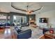 Elegant living room featuring hardwood floors, a fireplace, and large windows providing natural light at 10909 Mattioda Rd, Groveland, FL 34736