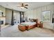 A spacious main bedroom features a fireplace, wood bed frame, and modern decor at 10909 Mattioda Rd, Groveland, FL 34736