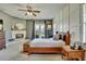 Cozy main bedroom boasting a fireplace, a wood-framed bed, and natural light at 10909 Mattioda Rd, Groveland, FL 34736