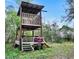 Charming wooden playhouse nestled amongst trees at 10909 Mattioda Rd, Groveland, FL 34736