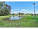 Scenic pond surrounded by lush greenery at 10909 Mattioda Rd, Groveland, FL 34736