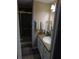 Bathroom featuring a vanity with a sink, mirror, and a glass-enclosed shower at 110 Oleander Cv, Leesburg, FL 34748