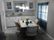 Cozy dining area with wood-look flooring, a pendant light fixture and ample cabinetry at 110 Oleander Cv, Leesburg, FL 34748