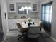 Cozy dining area with modern wood-look flooring, a pendant light fixture and ample cabinetry at 110 Oleander Cv, Leesburg, FL 34748