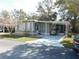 Charming home featuring a covered carport with room for a golf cart and a screened porch for outdoor enjoyment at 110 Oleander Cv, Leesburg, FL 34748