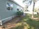 Side yard features well-maintained landscaping and exterior siding, enhancing curb appeal at 110 Oleander Cv, Leesburg, FL 34748