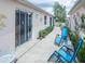 Backyard patio area with seating, complemented by landscaping and serene water views at 1137 Alfredo Ave, The Villages, FL 32159