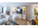 Living room with light wood floors, a media center, and views into other rooms at 1137 Alfredo Ave, The Villages, FL 32159