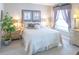 Cozy main bedroom with floral accents, soft lighting, and neutral tones at 1137 Alfredo Ave, The Villages, FL 32159