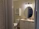 Well-lit bathroom with a vanity, oval mirror and toilet, offering a functional space at 1152 Villa Ln # 104, Apopka, FL 32712