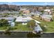 Aerial view of waterfront home with boat dock, lush greenery, and neighborhood setting at 11820 Watts Ct, Tavares, FL 32778