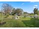 Waterfront backyard featuring a concrete picnic table area and partial view of a private dock at 11820 Watts Ct, Tavares, FL 32778