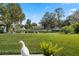 Backyard with green grass and canal at 11820 Watts Ct, Tavares, FL 32778