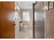 Bathroom featuring a tiled floor, toilet, framed mirror, and a glass-enclosed shower stall at 11820 Watts Ct, Tavares, FL 32778