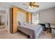 Bedroom featuring a murphy bed, ceiling fan, and a desk near the window at 11820 Watts Ct, Tavares, FL 32778