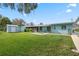 Backyard view of the home showcasing the yard and patio area at 11820 Watts Ct, Tavares, FL 32778