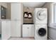 Laundry room area with stacked washer and dryer and extra storage at 11820 Watts Ct, Tavares, FL 32778