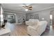 Cozy living room with neutral tones, a ceiling fan, and elegant decor at 11820 Watts Ct, Tavares, FL 32778