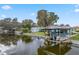 A Waterfront with a covered boathouse, channel, adjacent shed, and lush green landscaping at 11820 Watts Ct, Tavares, FL 32778