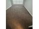 An empty bedroom with a window and brown carpeting at 11943 Iselle Dr, Orlando, FL 32827